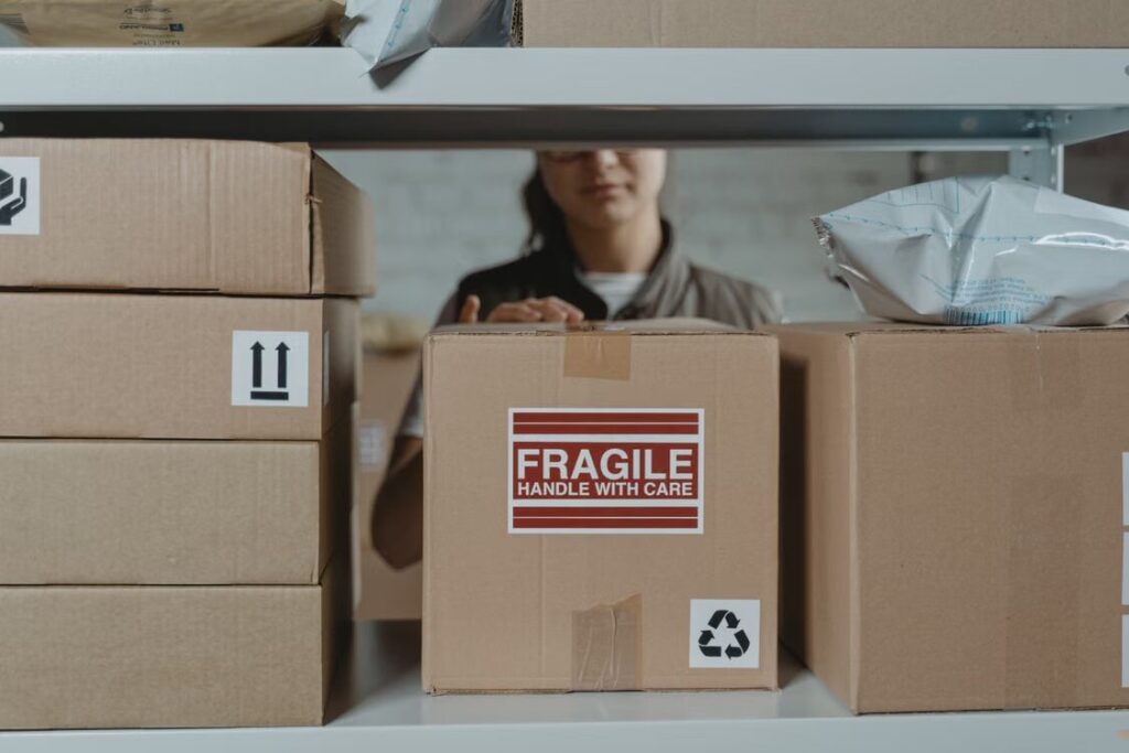 Warehouse staff inspecting a parcel upon arrival before repacking for international forwarding.